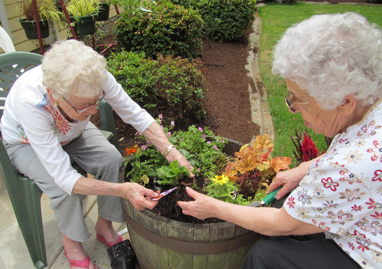 Rackleff Place residents planting flowers in the garden